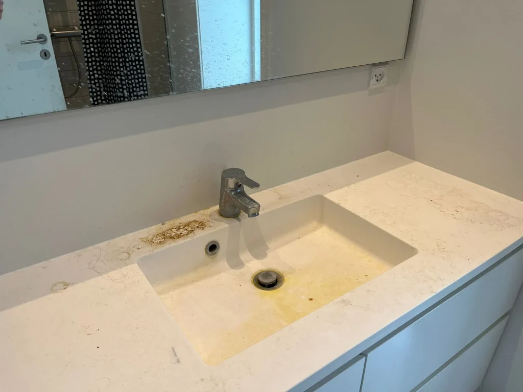 Håndvask og armatur med snavs og kalk før rengøring